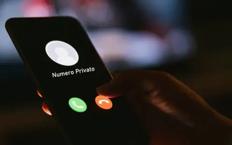 Schermo di un telefono con "Numero Privato" in arrivo. Un dito è pronto a rifiutare la chiamata, ma come richiamare un numero privato?