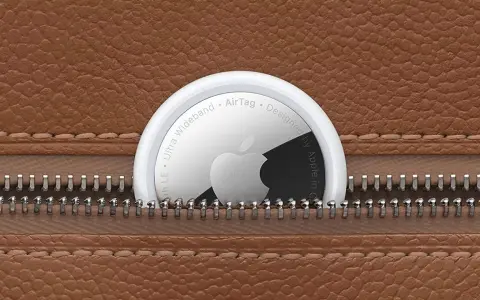 Un AirTag Apple sporge da una cerniera di una borsa in pelle marrone. Scopri airtag come funziona per ritrovare i tuoi oggetti.